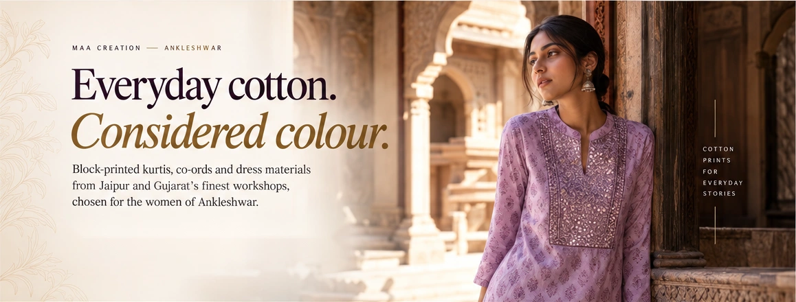 Woman in a lavender block-printed cotton kurti with mirror-work yoke by a carved haveli doorway