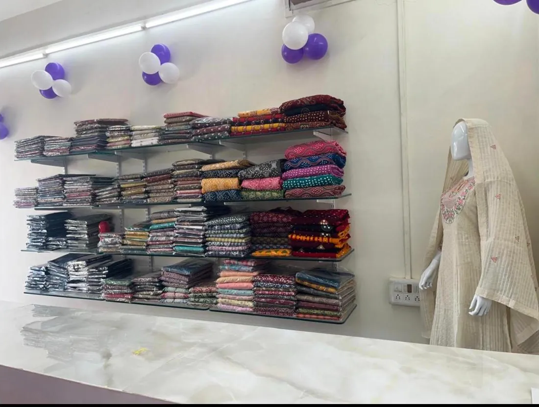 Inside Maa Creation: shelves of folded kurtis and a mannequin